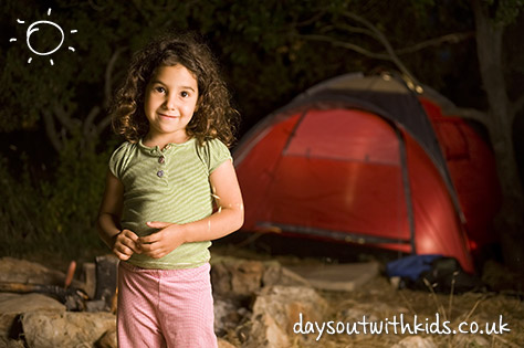 bigstock-little-girl-at-a-camp-at-night-19485344