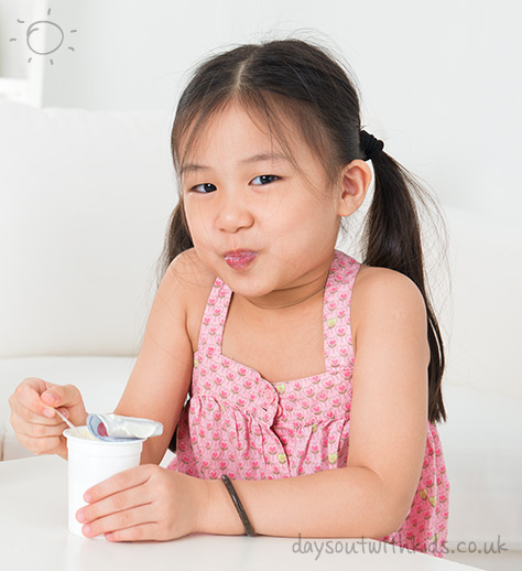 bigstock-Eating-yogurt-Happy-Asian-kid-49242812