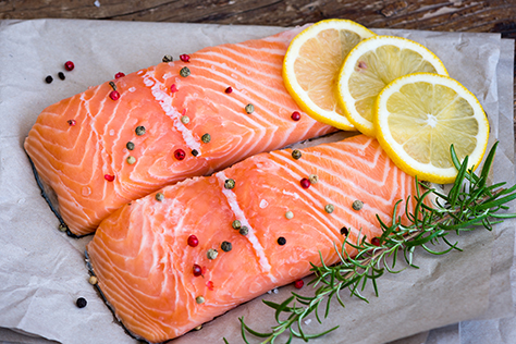 Detail of Raw Salmon Fish Fillet with Lemon Spices and Fresh Herbs Ready for Cooking