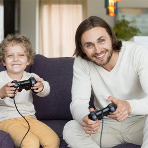 son and father playing an xbox game together
